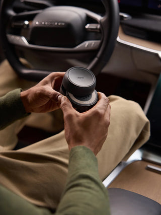 A black, cordless Pura Car Pro diffuser designed for use in vehicles.
