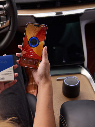 A black, cordless Pura Car Pro diffuser designed for use in vehicles.