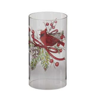 Clear glass vase with a red cardinal and winter elements design on a white background. Clear Glass Cardinal & Pinecone Candle Slip Cover