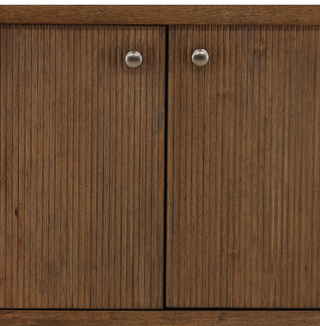 Wooden sideboard with four doors and a shelf on a white background medium stain gold knobs