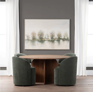Dining room with a wooden table and green chairs, framed abstract art on the wall.
