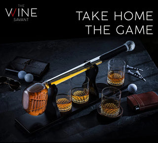 A whiskey decanter set featuring a golf club-shaped decanter and four whiskey glasses arranged on a mahogany wood base.