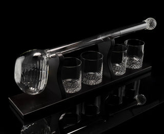 A whiskey decanter set featuring a golf club-shaped decanter and four whiskey glasses arranged on a mahogany wood base.