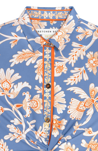 A close up of the Gretchen Scott Twist & Shout Dress with ¾ sleeves, a center front racer stripe banding, and a floral pattern in periwinkle colors.