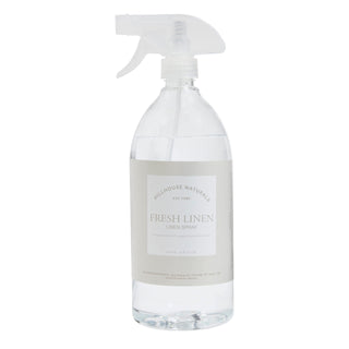 A clear spray bottle labeled 'Hillhouse Naturals Fresh Linen' indicating a fresh linen scent.