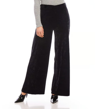 A pair of black crushed velvet pants with a high-rise waist and wide-leg design, featuring an elasticized waistband.