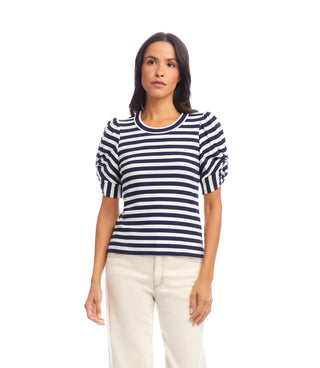 Woman wearing a navy and white striped sweater on a white background