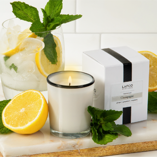 LAFCO Champagne Votive candle set in a kitchen next to the product box and a lemon