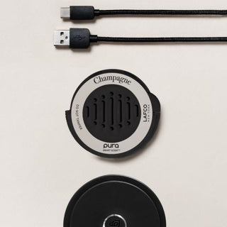 LAFCO Champagne Pura Car insert posed with Pura Car device and cord.