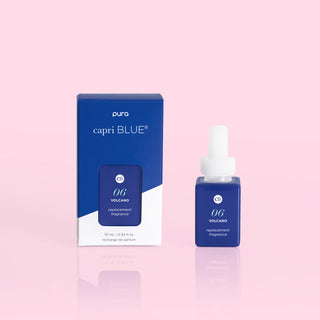 A Pura diffuser refill bottle in the Volcano scent, next to its packaging box which is blue and white with 'capri BLUE' branding. PURA Capri Blue Volcano Pura Refill