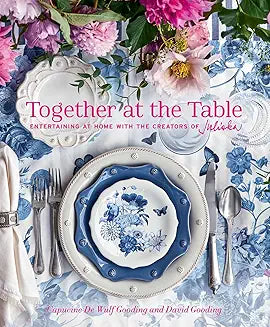 Book cover of 'Together at the Table: Entertaining at home with the creators of Juliska' featuring a table setting with blue and white dishes, cutlery, and a floral patterned tablecloth. Together at the Table.