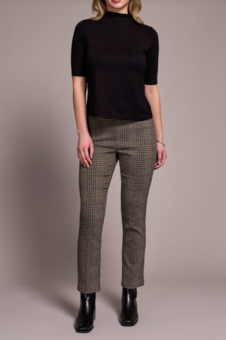 Person wearing a black top and plaid pants on a plain background