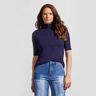 A model wearing a navy blue mock neck, cotton tee with sleeves that go to the elbow.