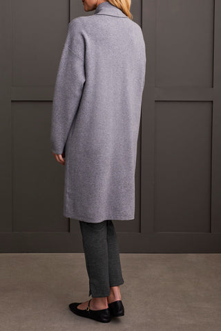 A person wearing a heathered charcoal open-front coatigan with patch pockets over a gray sweater and black pants.