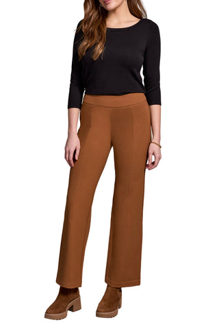 Woman wearing a black top and brown pants on a neutral background. Tribal Pull On Pant with Pin Tucks in Walnut