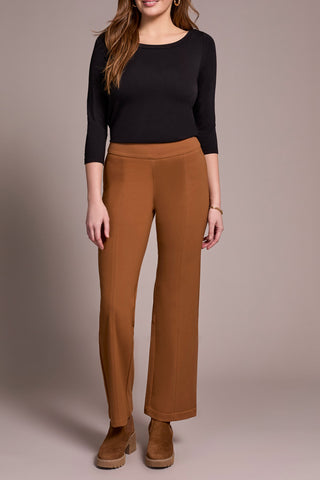 Woman wearing a black top and brown pants against a neutral background. Tribal Pull On Pant with Pin Tucks in Walnut