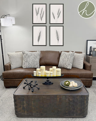 Living room with brown sofa, decorative pillows, and a brown wood coffee table.