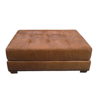 Brown leather ottoman on a white background