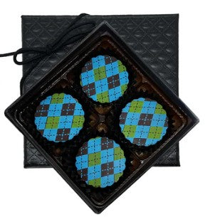 Four blue and green checkered caramels in a black tray with a textured surface.