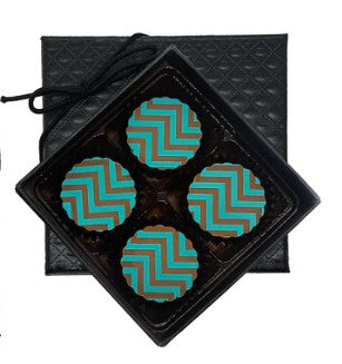 Four teal caramels with a geometric pattern in a black rectangular container on a white background