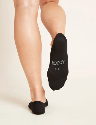 A person wearing black no-show socks designed to be hidden inside shoes, organic viscose bamboo