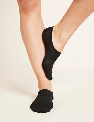 A person wearing black no-show socks designed to be hidden inside shoes, organic viscose bamboo