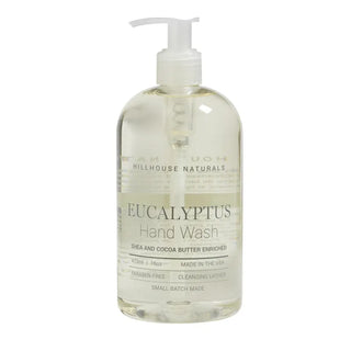 A clear pump bottle of Hillhouse Naturals Eucalyptus Hand Wash with a label that includes the product name and a mention of being shea and cocoa butter enriched.
