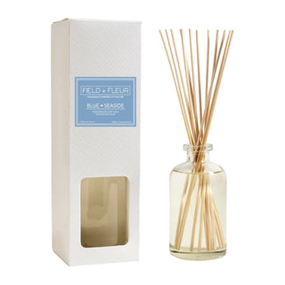 A Hillhouse Naturals diffuser set, including a clear glass bottle with reeds and a white box packaging with the product name 'Blue Seaside'