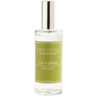A clear glass spray bottle labeled 'Hillhouse Naturals Cut Grass Fragrance Mist' with a silver cap.