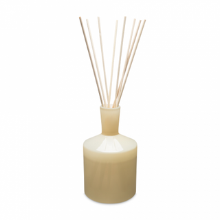 A beige LAFCO chamomile lavender diffuser with several wooden reeds visible at the top.