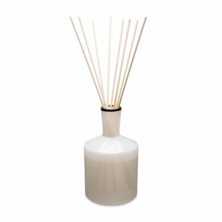A beige LAFCO champagne 6 oz diffuser with glass and wooden reeds.