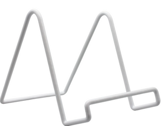 A white wire easel stand for displaying art canvases.