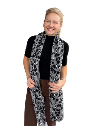 Woman in Animal Print Knitted Scarf in Ash Dark Grey
