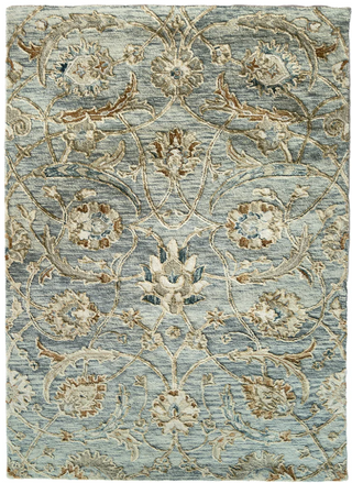 A traditional style wool rug with a blue background featuring stylized mosaic patterning and hand-tufted accents.