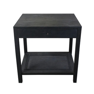 A black cane end table with a four-post design, featuring a sliding drawer and a shelf with a natural cane/rattan weave pattern.