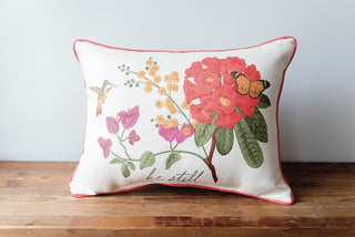 An inspirational pillow with a floral design and a hummingbird, featuring a message sure to uplift and encourage.