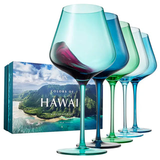 A set of five wine glasses in varying shades of blue and green, each with a large stem and a wide bowl, displayed against a white background.