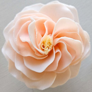 A petal-shaped soap with a layered design in shades of pink and a yellow center, resembling a flower.  Bell Grace Petite Soap Flower