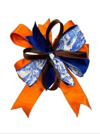 Blue & White Toile with Orange Bow
A decorative bow with orange grosgrain ribbon, royal blue velvet loops, and blue-and-white patterned ribbon loops, tied with a brown leather center ribbon velvet satin fall Halloween