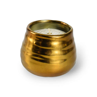 A Bourbon Royalty White Linen gold 8 oz Midas candle with a white wick and a label in the center.