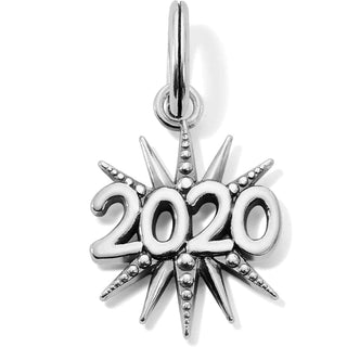 A silver-colored charm in the shape of a star with the year 2020 inscribed in the center, adorned with small clear crystals. Brighton