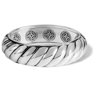 A silver scalloped hinged bangle bracelet with intricate designs on the inside. Brighton