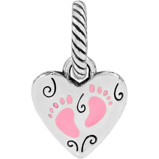 A silver charm featuring a heart shape with pink footprint designs inside. Brighton