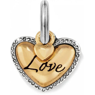 A two-tone heart-shaped charm with the word 'Love' inscribed in the center, attached to a silver chain. Brighton