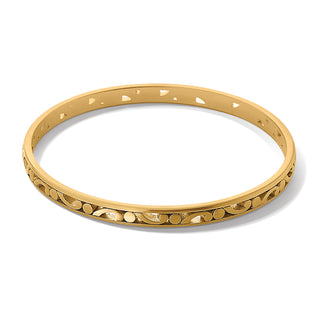 A gold-colored slim bangle bracelet with intricate detailing along the band. Brighton