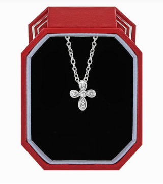 A silver-colored Brighton Enchanting Cross Necklace with rhinestone embellishments, displayed in an elegant presentation case with a red and gray interior. Brighton