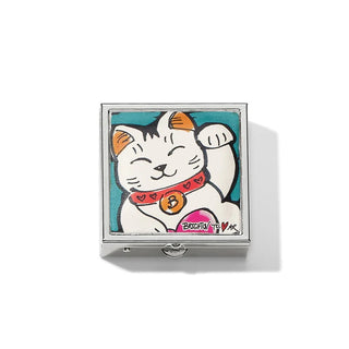 A pill box with a leather top closure featuring a colorful illustration of a waving cat, resembling the Maneki Neko, on a teal background with the word 'Brighton' and a heart symbol.