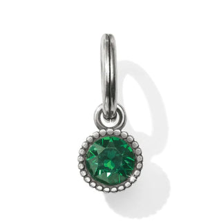 A faceted emerald-colored crystal amulet with a metallic ring for attachment. Brighton