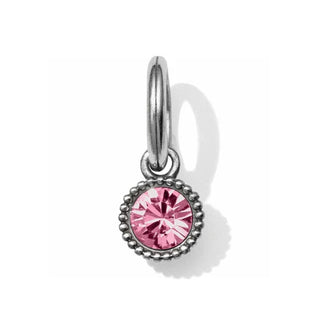 A silver-colored amulet with a faceted pink crystal centerpiece and a decorative border. Brighton