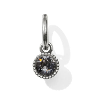 A silver-colored birthstone amulet with a faceted design, attached to a silver chain. Brighton